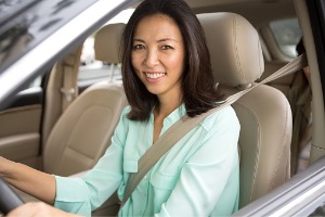 Happy woman in sitting in car